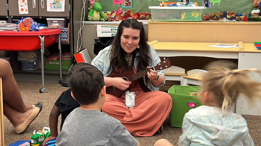 Music teacher singing to kids
