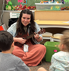 Music teacher singing with kids