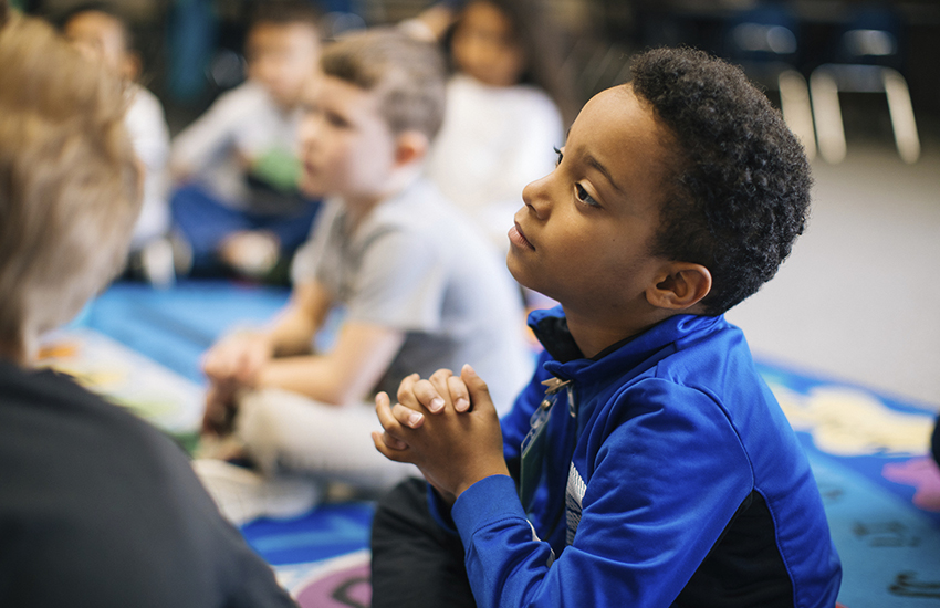 A kindergartner listens intently at LIberty Elementary in 2018. 