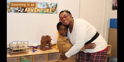 A fourth grade boy hugs his mother inside a school