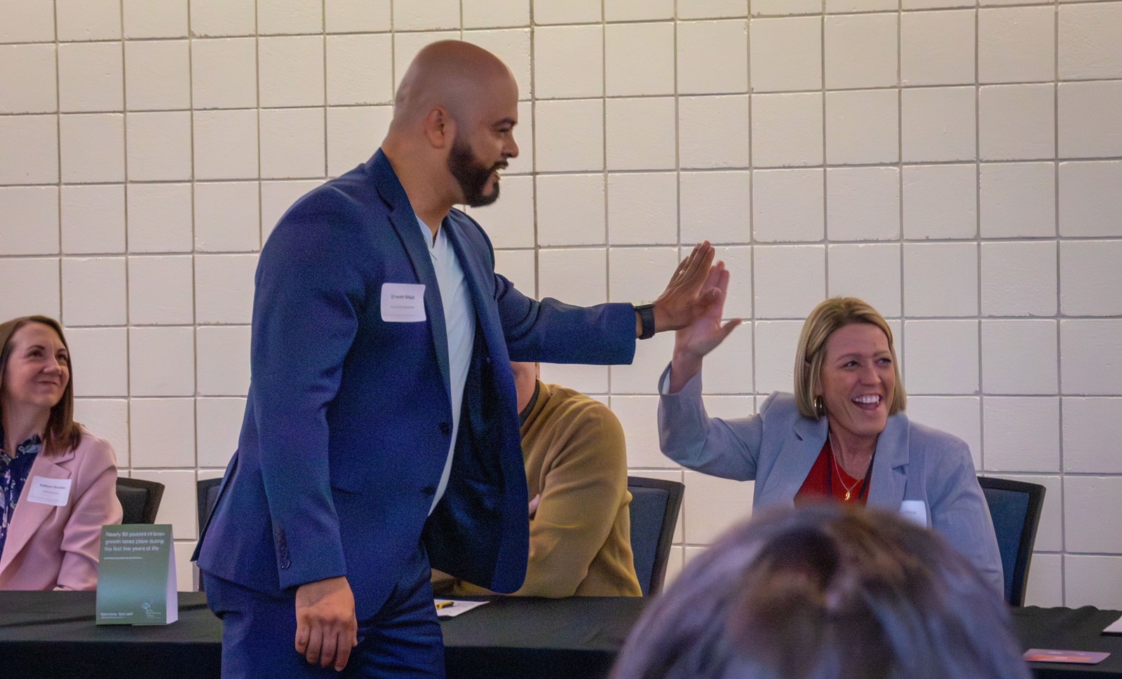 Ernesto Mejia high-fives an elementary school principal at a breakout session after the 2026 Superintendents' Early Childhood Plan convening