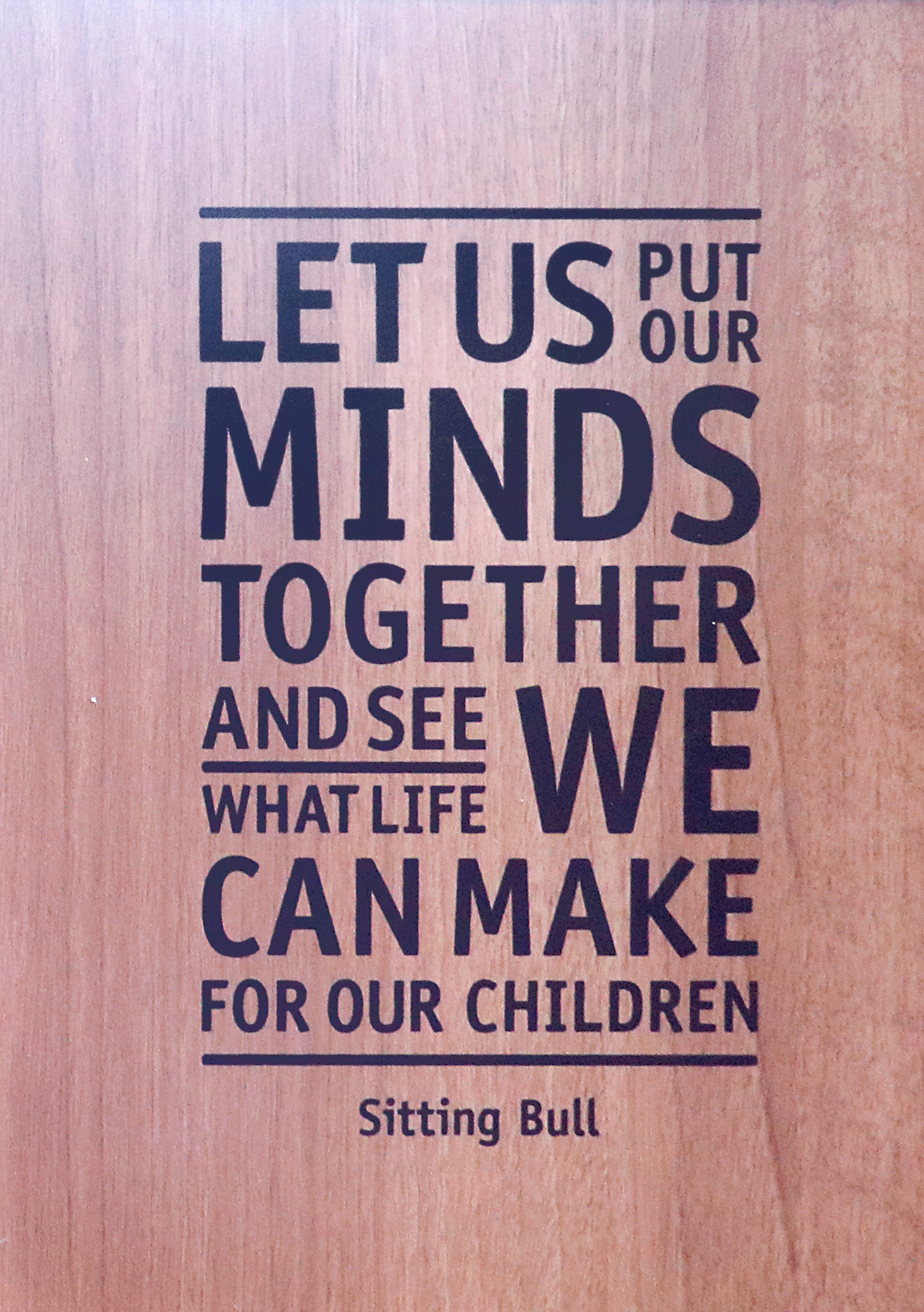 Writing on a wall with a quote from Sitting Bull: "Let us put our minds together and see what life we can make for our children"