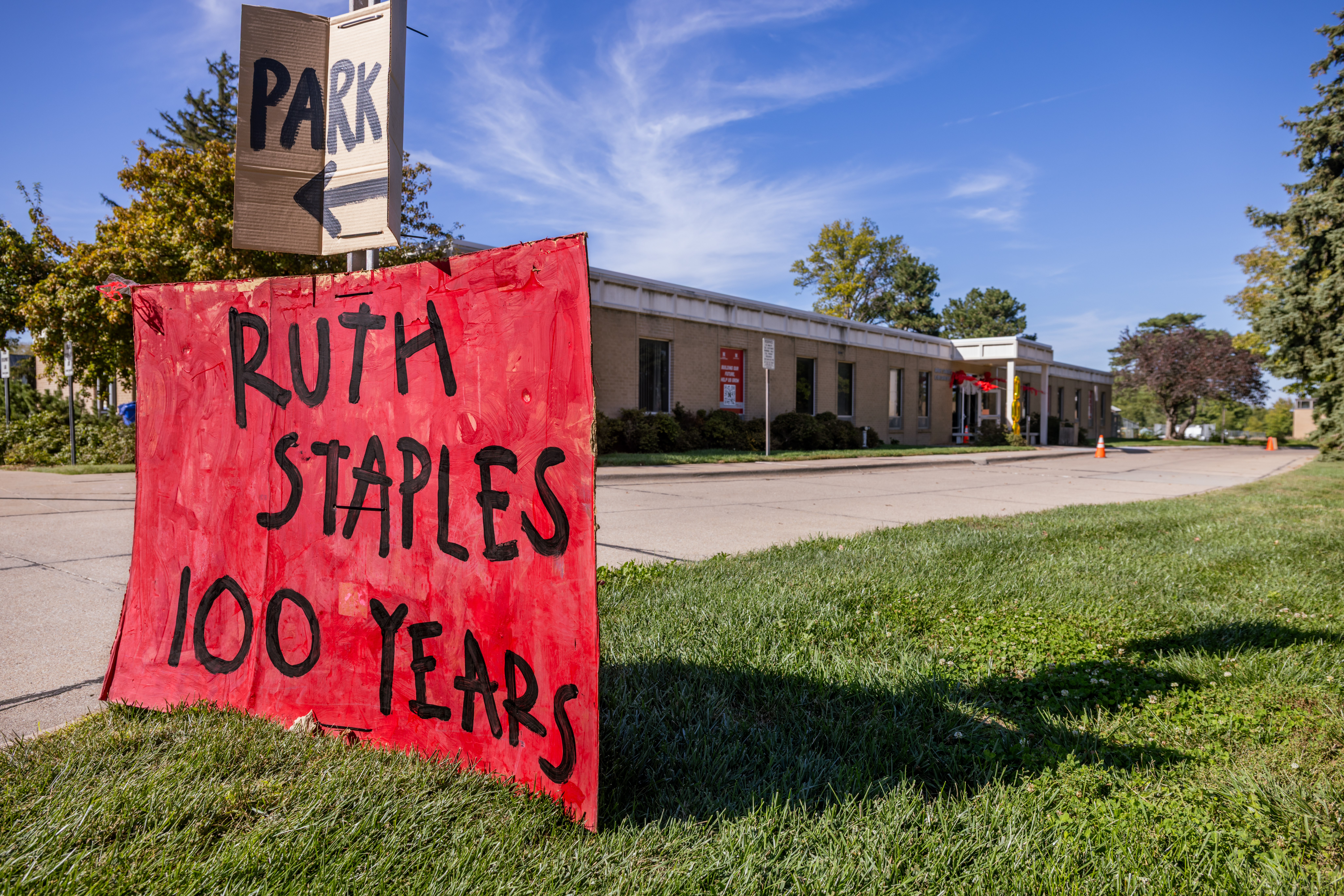 A red sign outside the Ruth Staples Child Development Lab says, "Ruth Staples 100 Years"