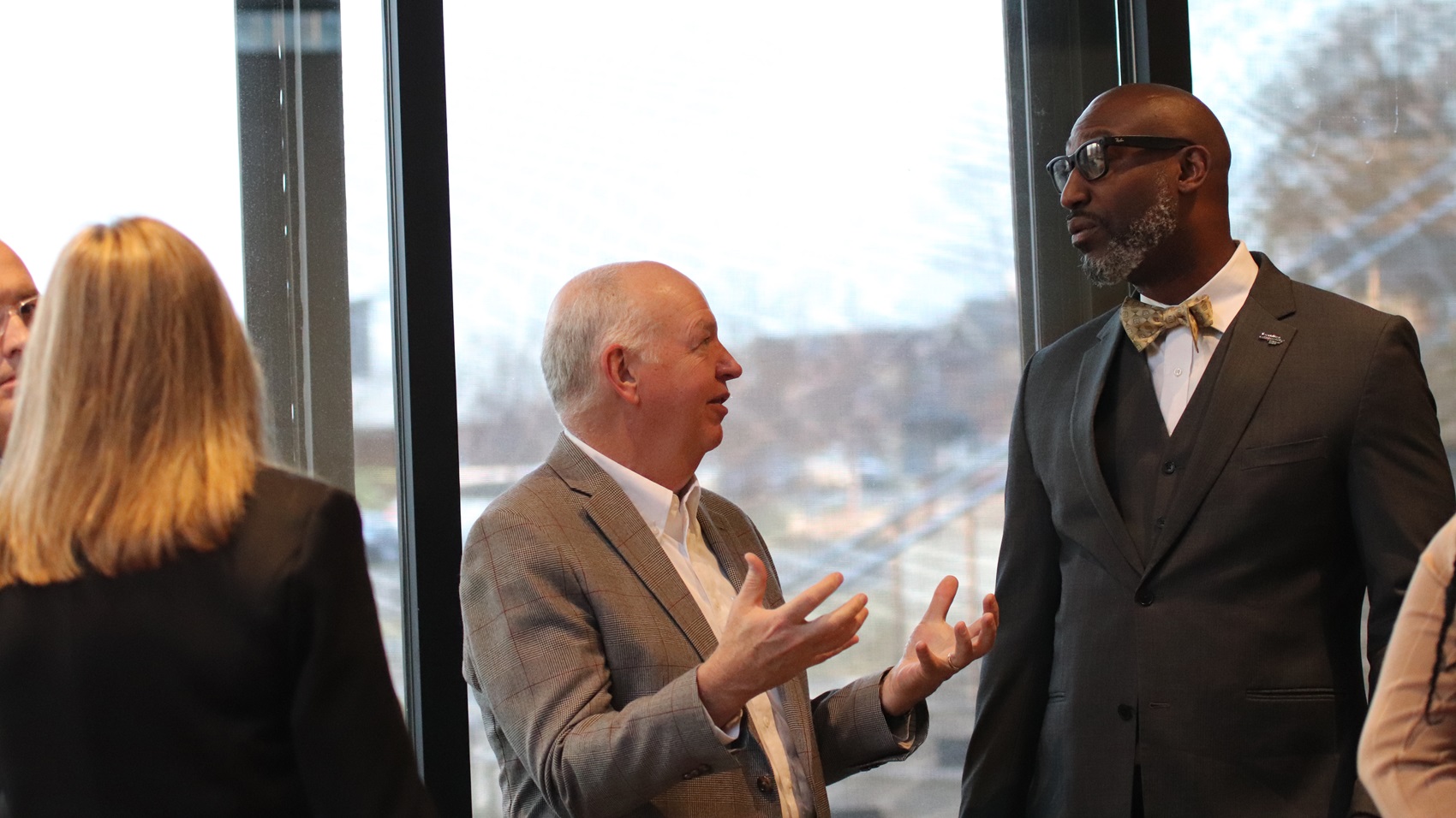 Two men standing together and talking