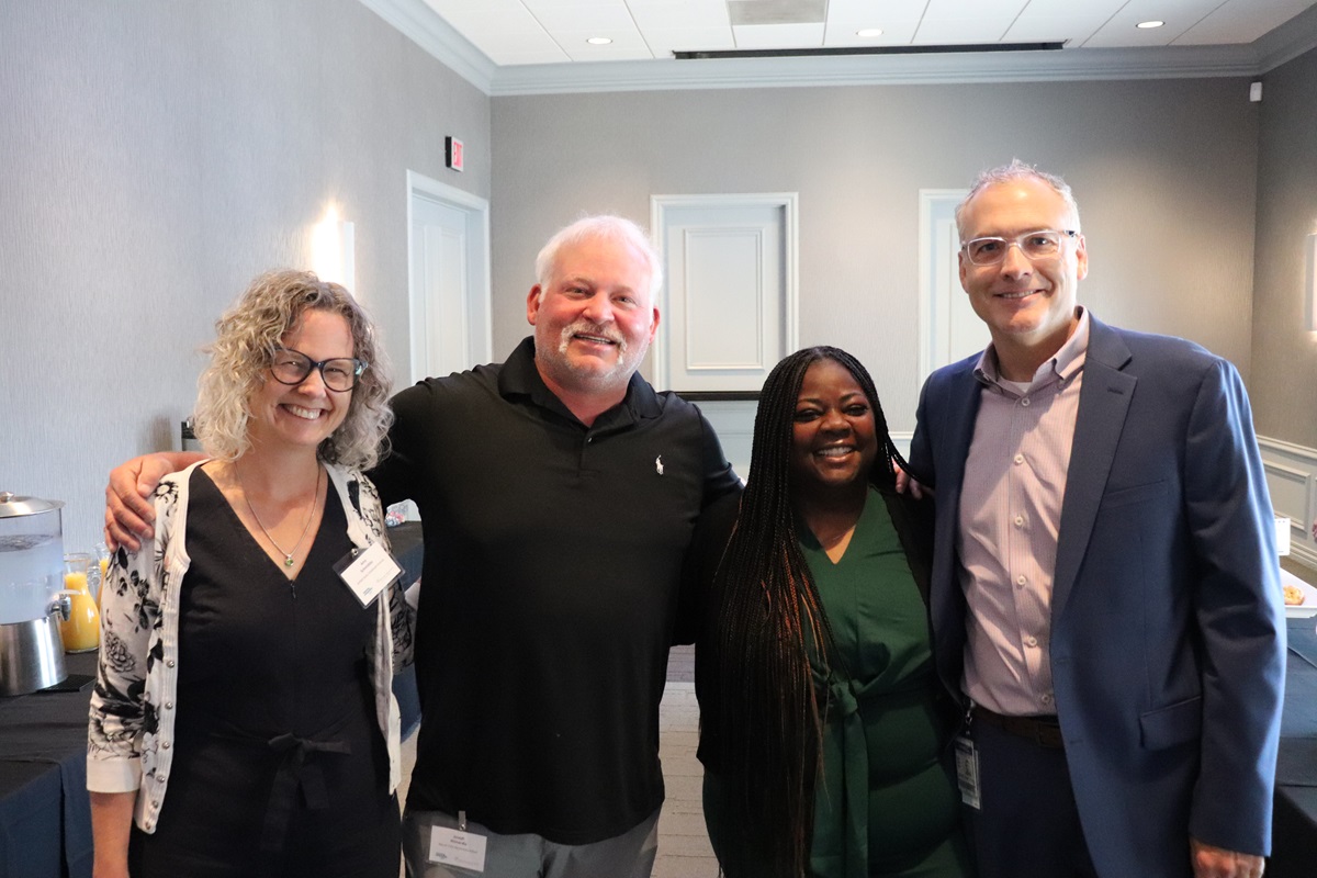 Four people standing together