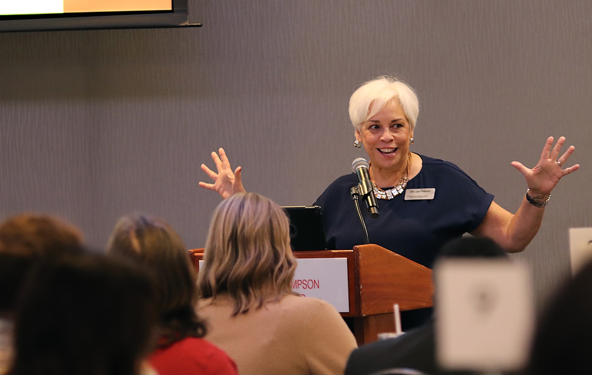 A woman speaking at a podium