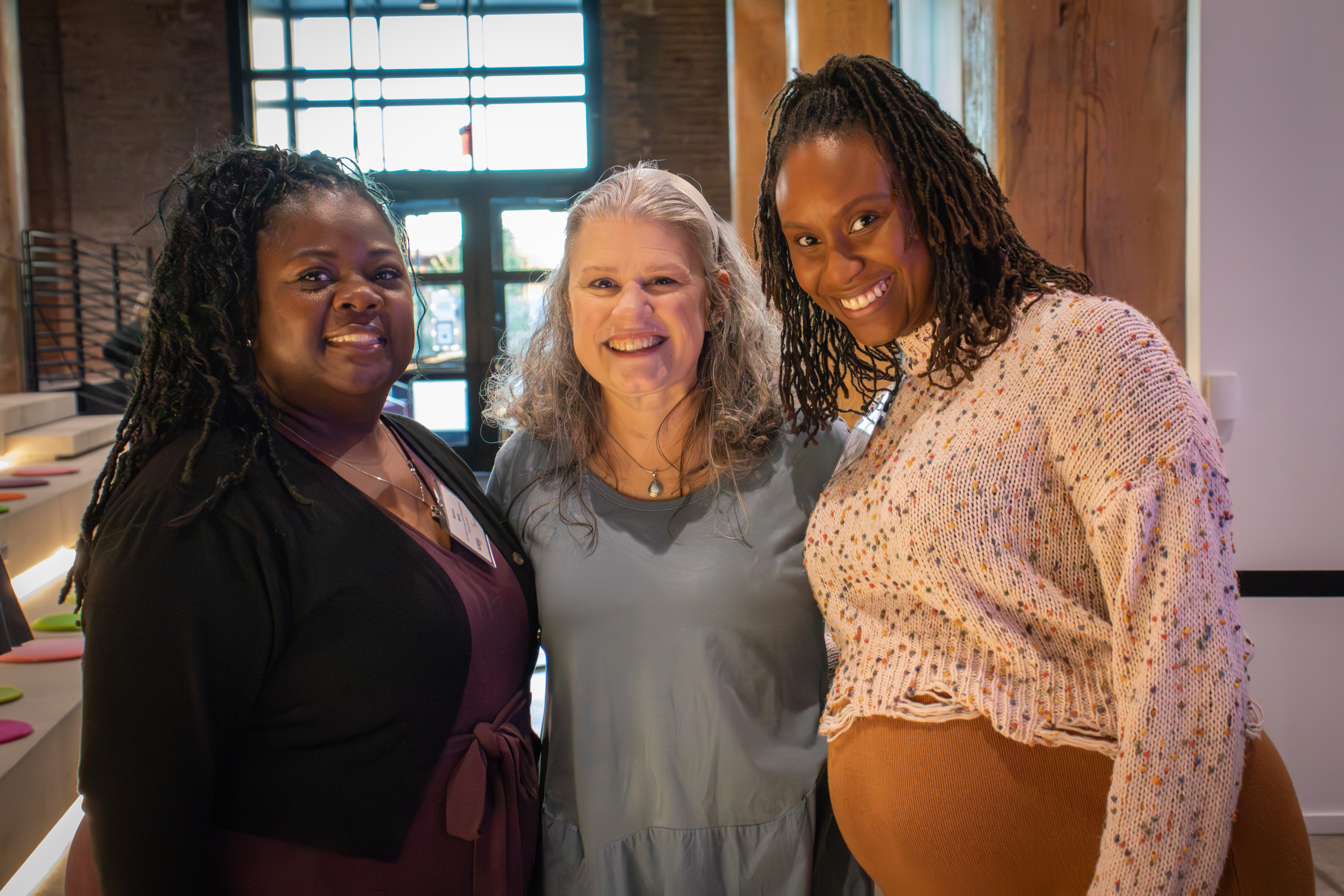 Three women pose together