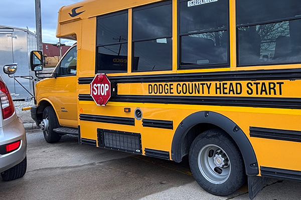 A small yellow school bus that says Dodge County Head Start on its side