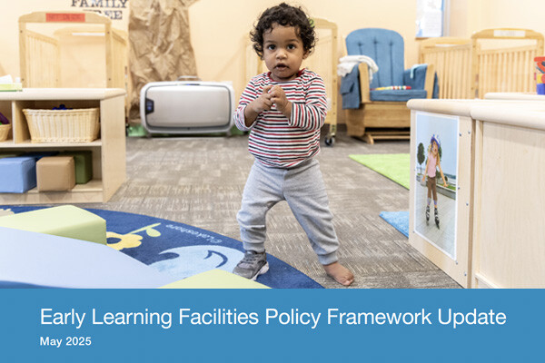 A toddler standing inside a classroom