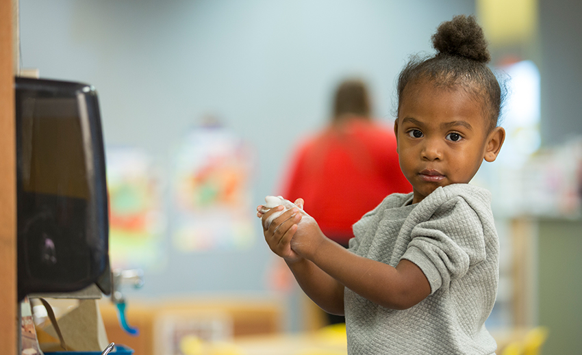 young girl washing hands