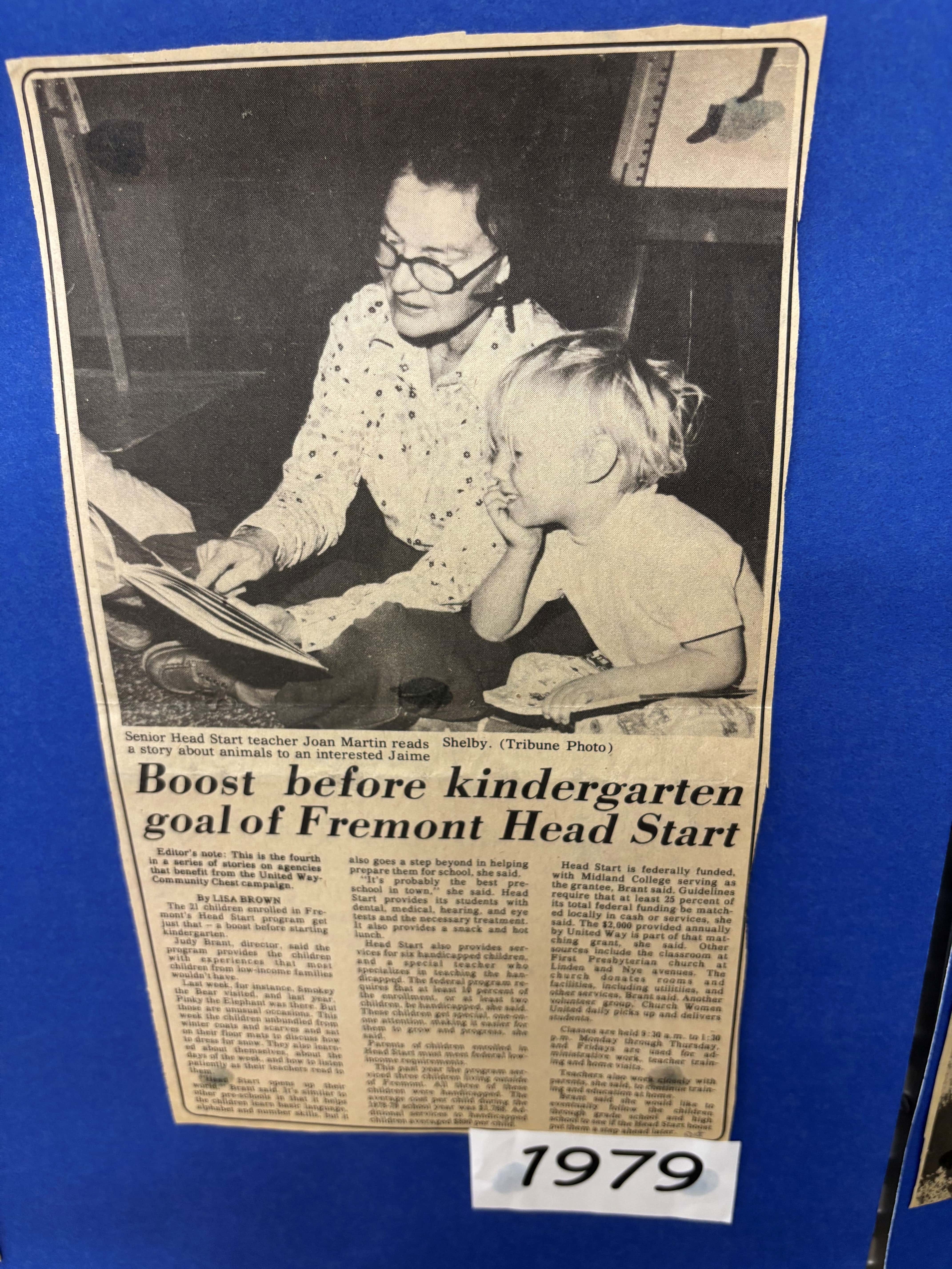 Newspaper clipping with a black-and-white photo of a teacher reading to a young child, with the headline about Fremont Head Start and a “1979” label below.