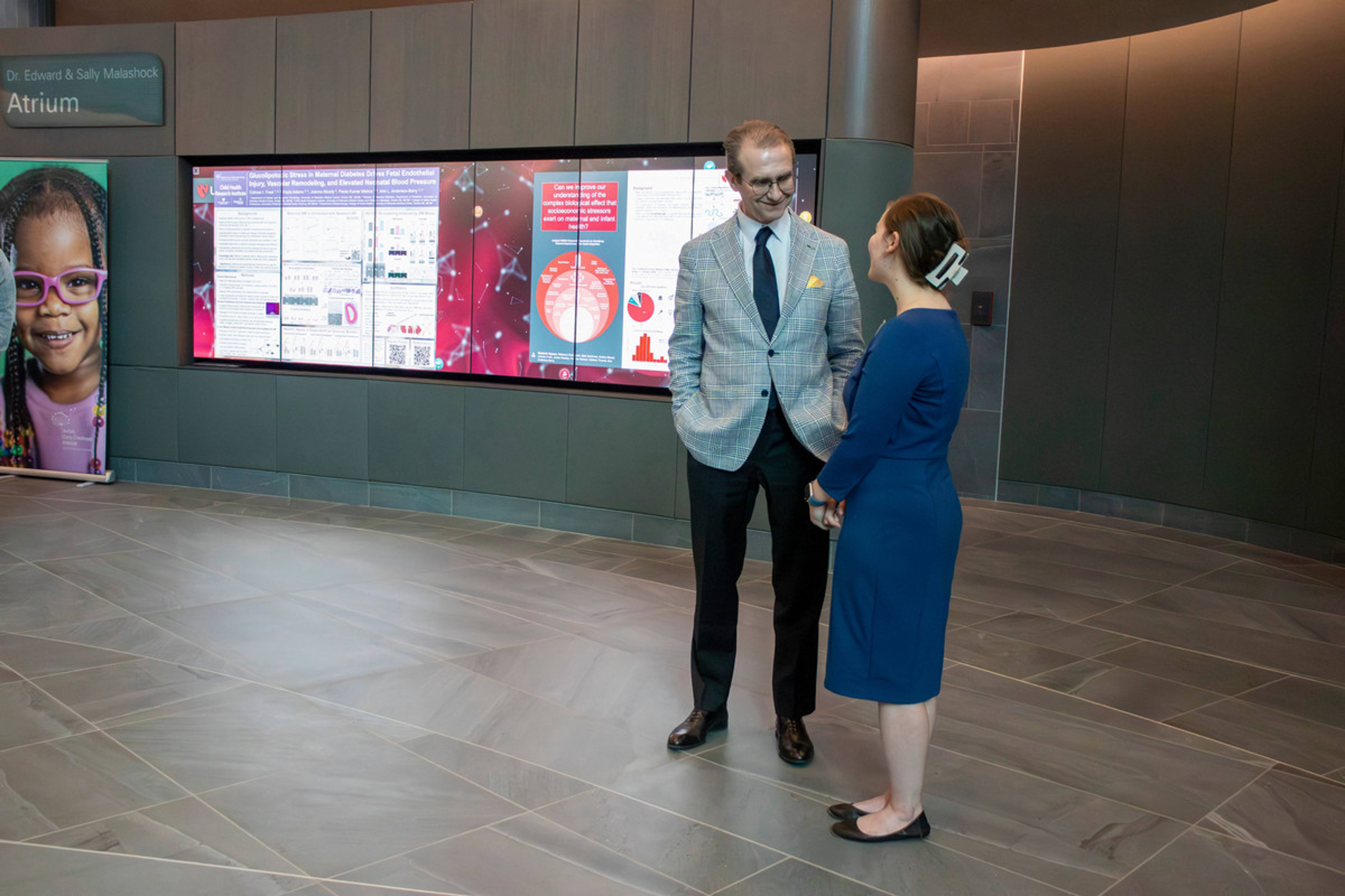 UNMC Ph.D. student Rebekah Rapoza talks to Buffett Institute Executive Director Walter Gilliam