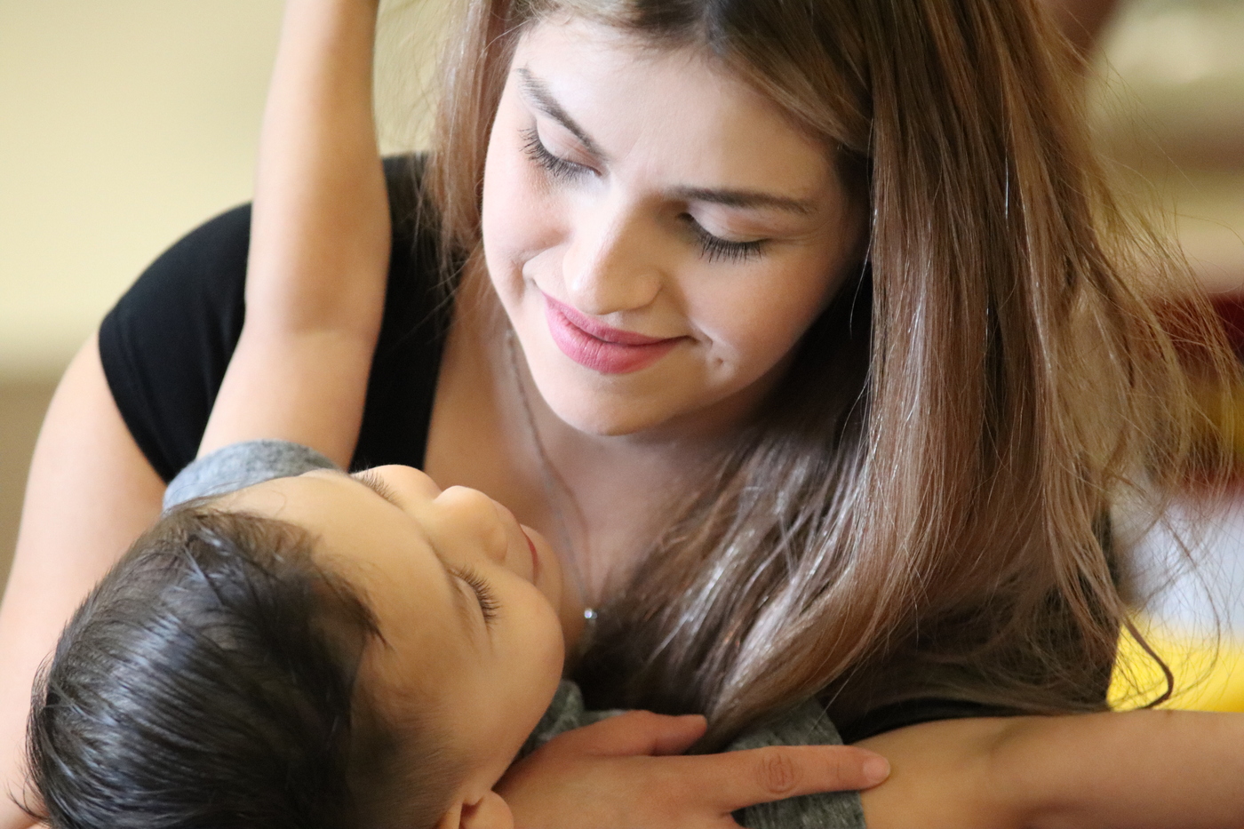A mother holds her toddler-age son