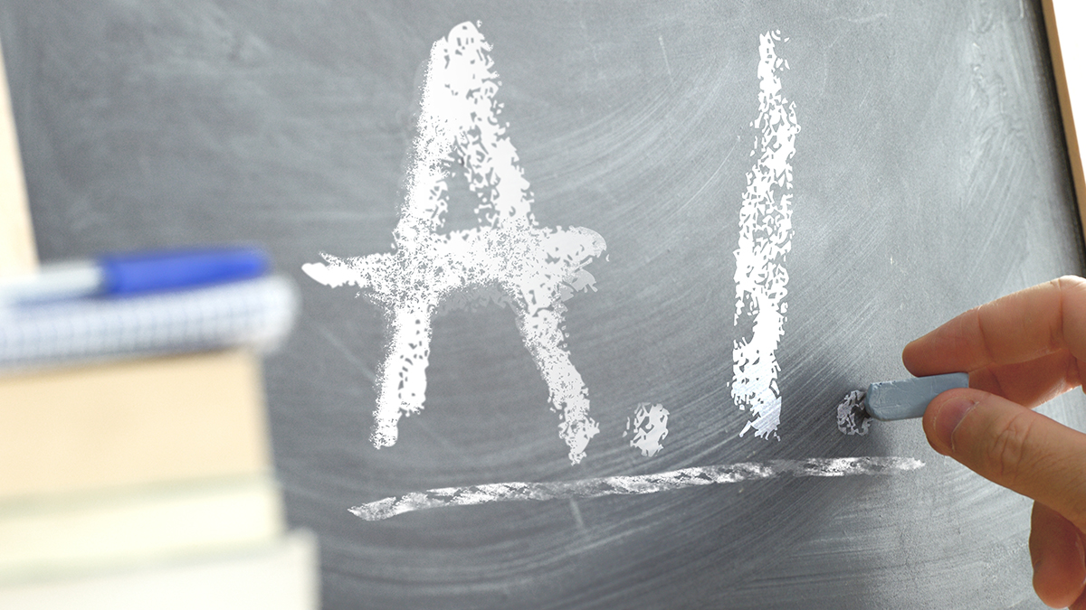 Hand writing “A+” on a chalkboard.